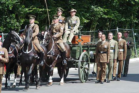 Military cortège transferring the 250th and final body from the mass graves of Pheasant Wood to the new cemetery during the opening ceremony on 19 July 2010 /